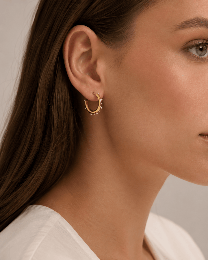 Pearl hoop earrings worn on the ear