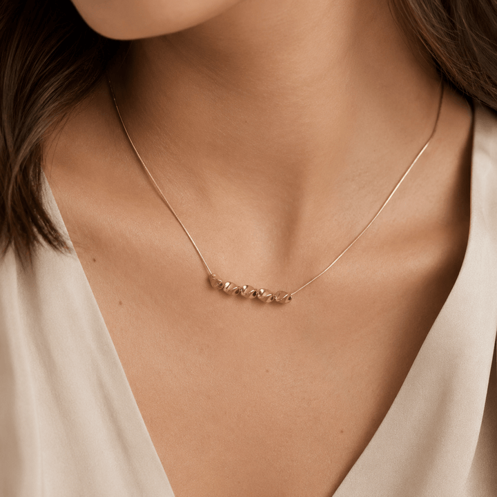Beaded necklace worn at the neckline